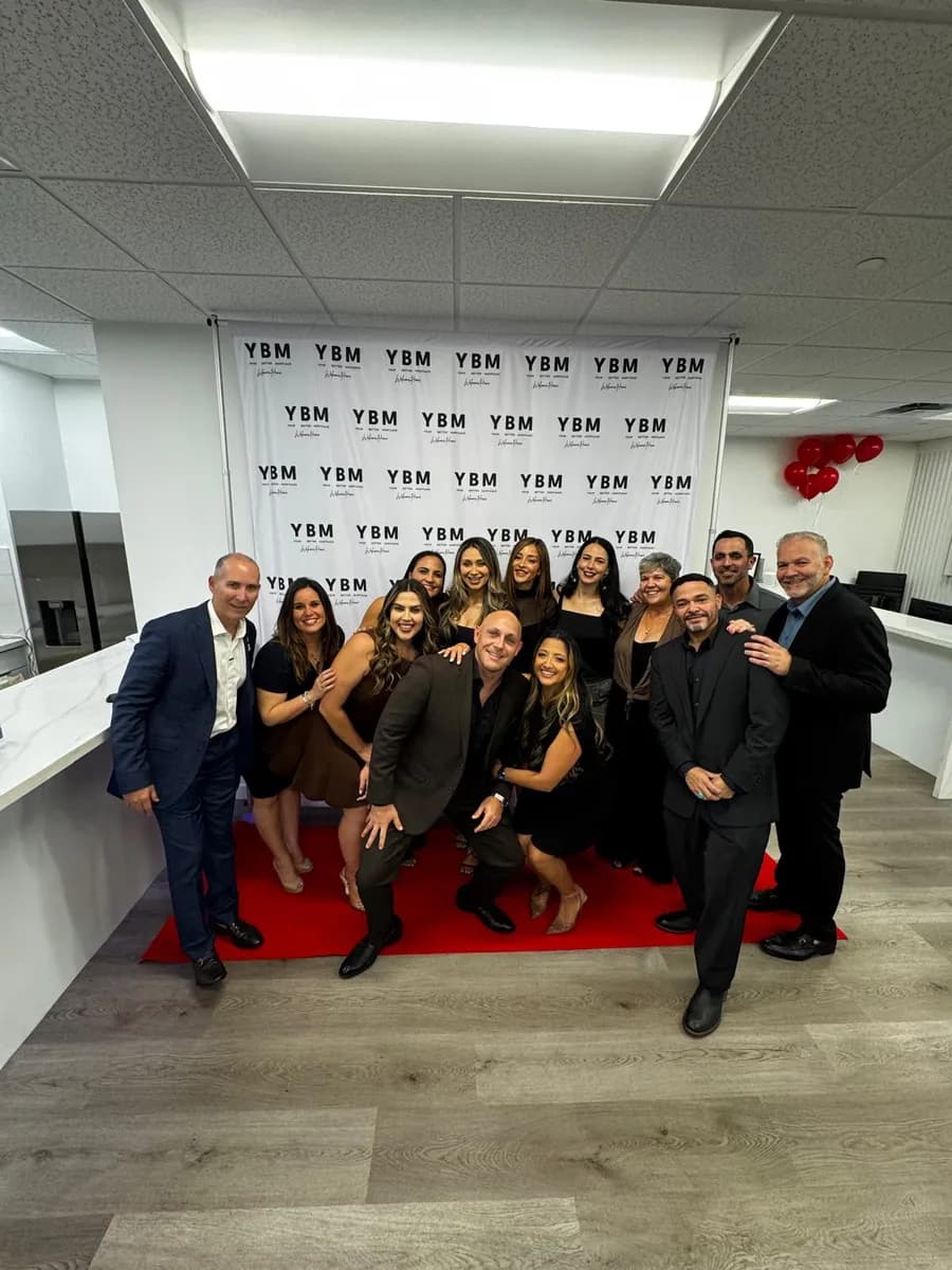 The team celebrating at a YBM event